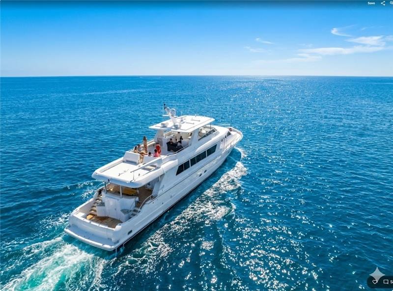 Exterior view of a luxury charter yacht cruising in open waters