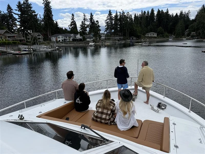 Guests enjoying a private San Juan Alaska yacht charter on open deck